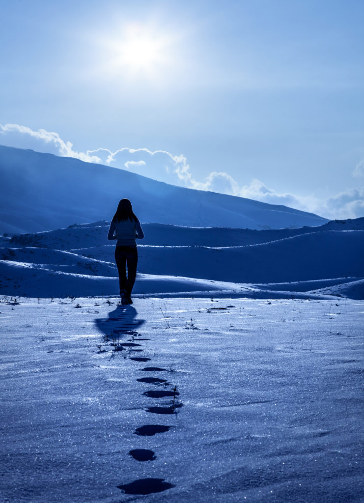 woman walking alone in snow searching for her life purpose