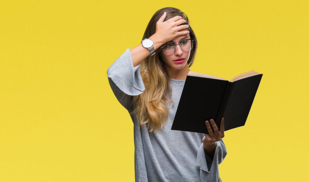 woman reading a book confused and overwhelmed